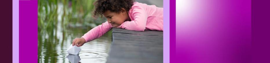 young girl on dock leaning over water