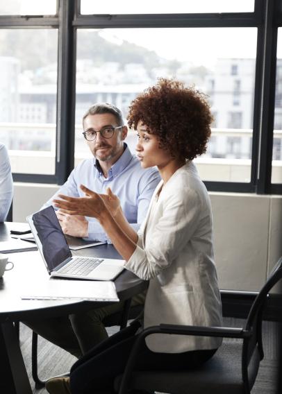 Divers group of five adults sitting around a conference table