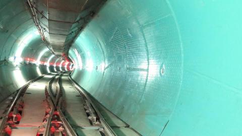 Tunnel with aqua walls and tracks on ground