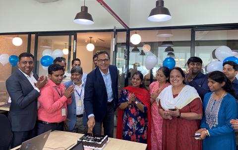 Team posing for a photo at office opening