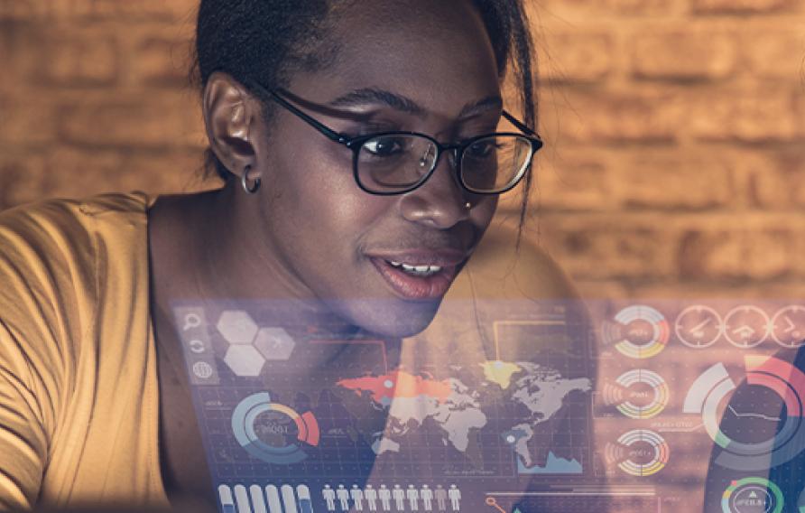 Black woman and mideast woman looking at a hologram of location based data