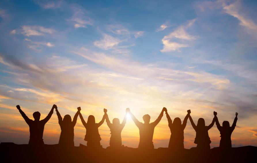 Line of people holding hands in the air