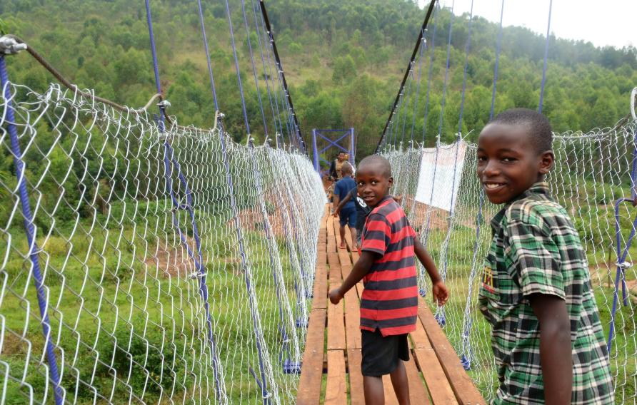 Kids crossing a footbridge in Rwanda