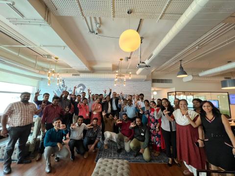 Team posing for a photo at office opening