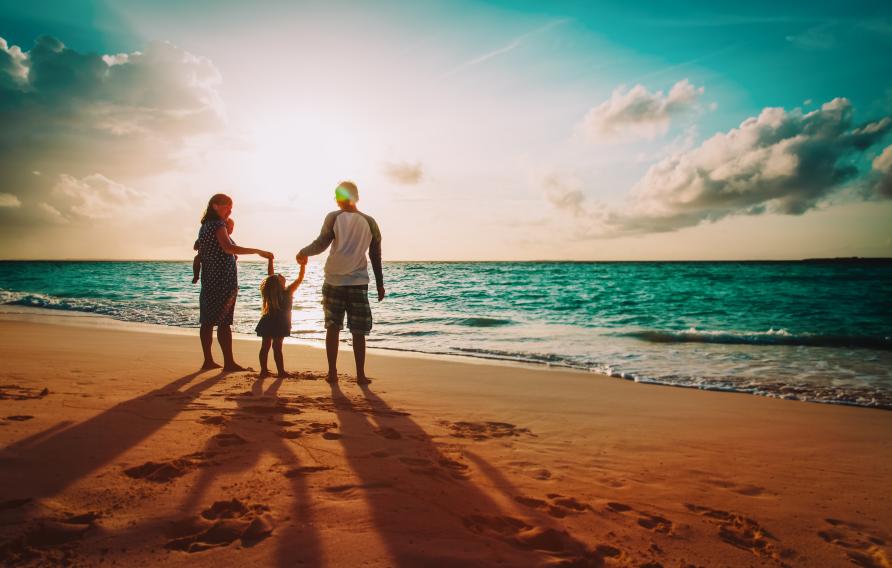 Family on a beach at sunset