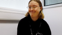 Blond woman in glasses and black sweatshirt